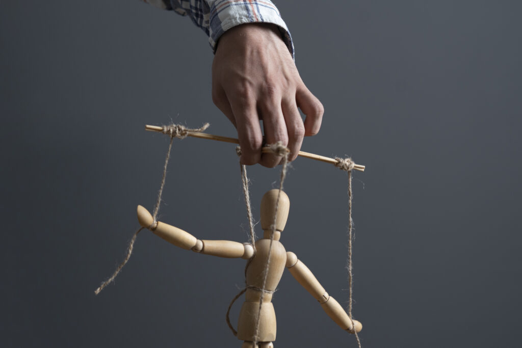 hand manipulate threaded puppet marionette, human manager master
