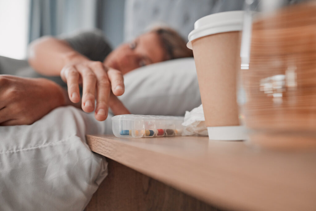Depression pills, insomnia medicine and woman sleeping in bed for pharmaceutical, psychology or men.