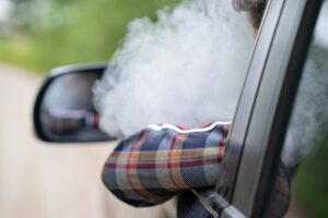 man smoking in a car