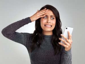 I dont know what to say to this. Shot of a woman looking upset while looking at her cellphone