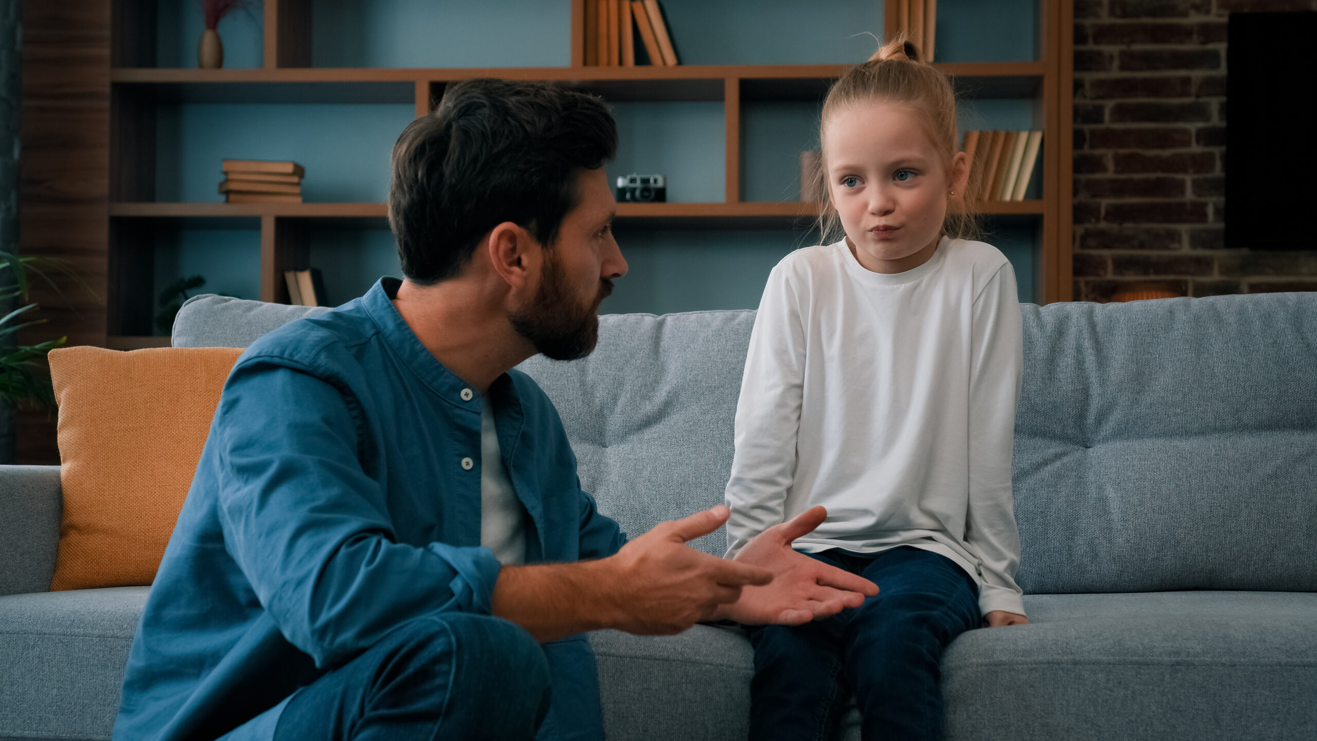 Caring father caucasian man dad trying to contact with offended child girl helping little kid daughter talking sincerely about misunderstanding problem mistrust between children and parents in family. High quality 4k footage