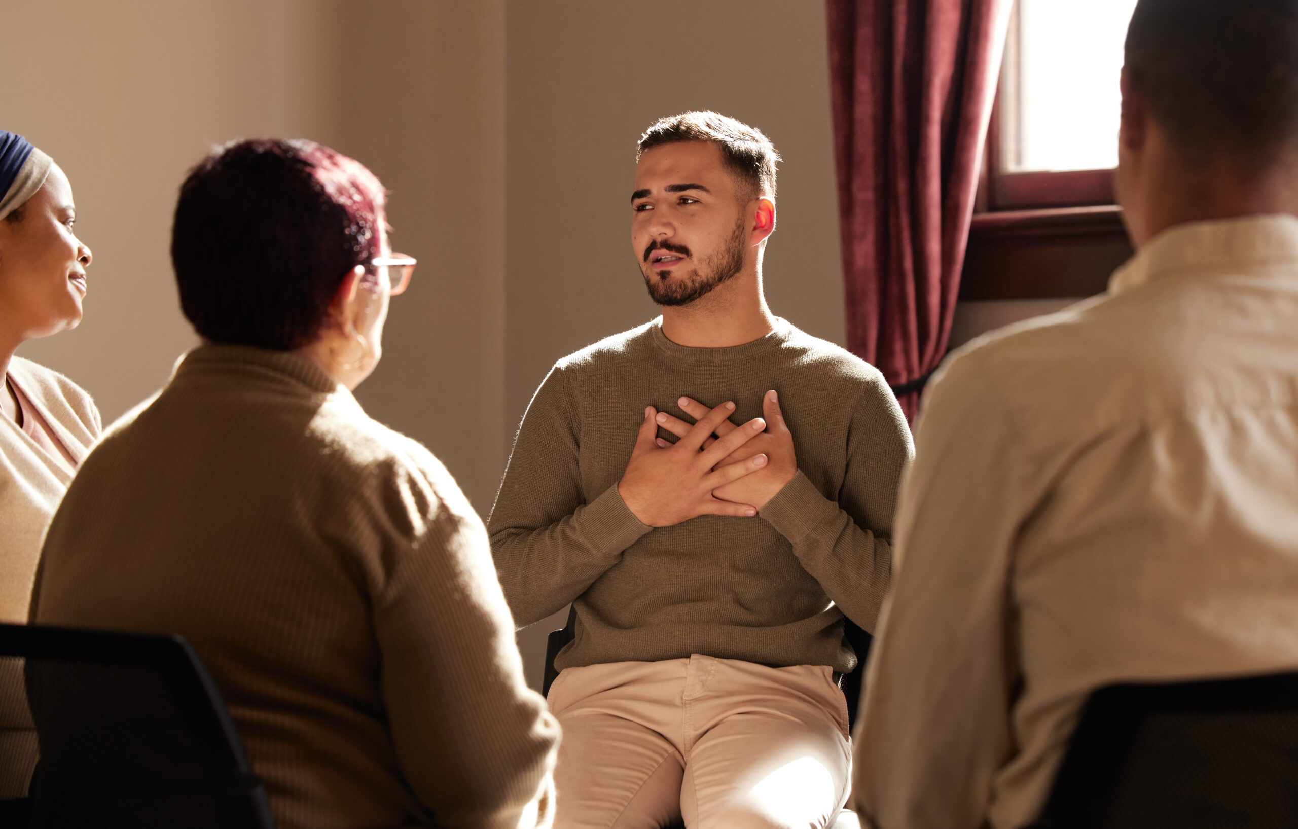 Support, trust and man sharing in group therapy with understanding, feelings and talking in session.