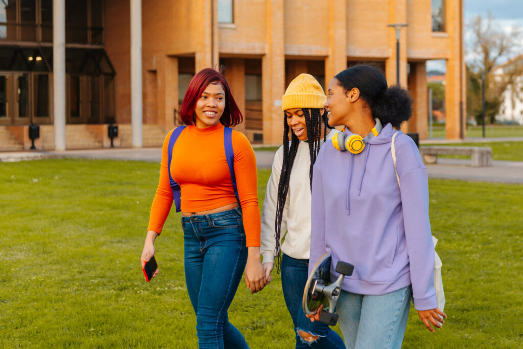 multiracial group (latina and black) of teenage friends and high school classmates chatting and walking after school. friendship and unity. back to school.