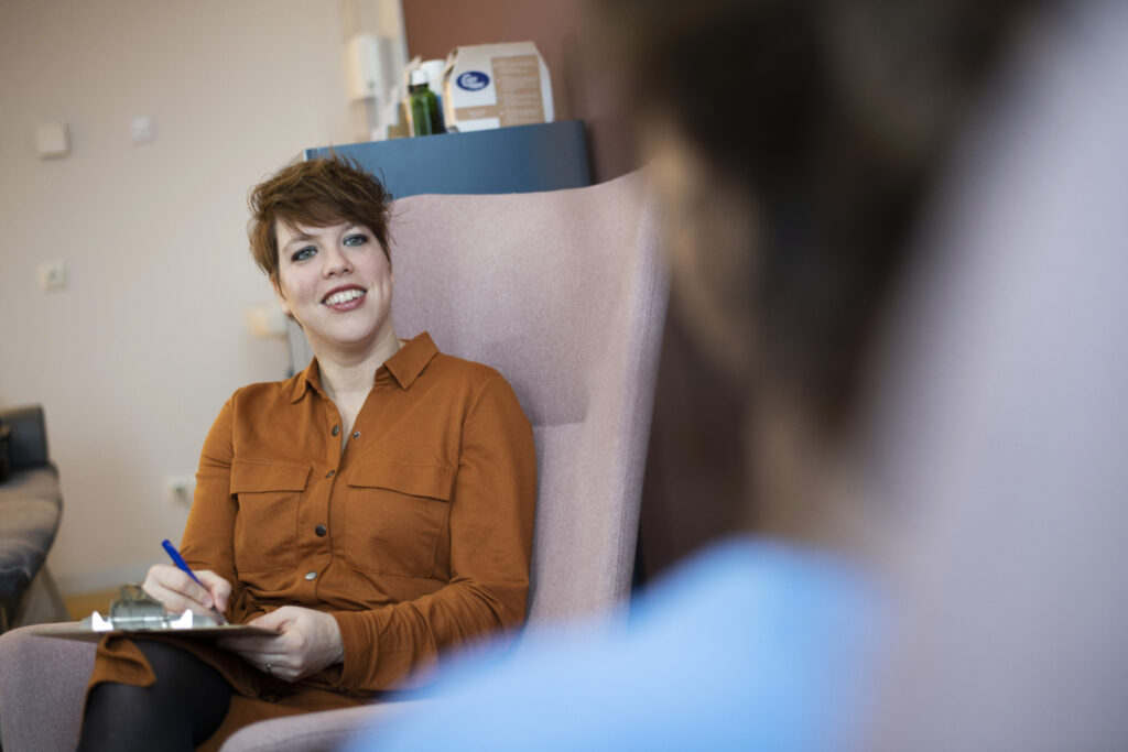 Woman filling out a questionnaire in a medical setting