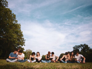 large group of friends enjoying a summer day at the park, back to school