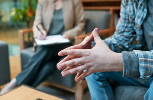 Cropped shot of a man having a therapeutic session with a psychologist.
