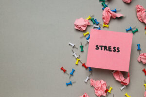 Paper, word Stress and needles on gray background, space for text