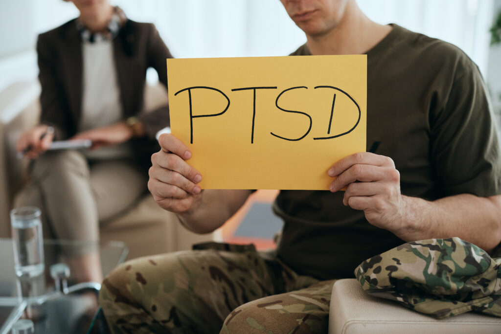 Close-up of military man with PTSD placard during mental health therapy.
