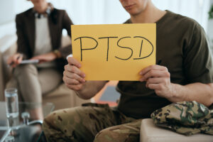 Close-up of military man with PTSD placard during mental health therapy.